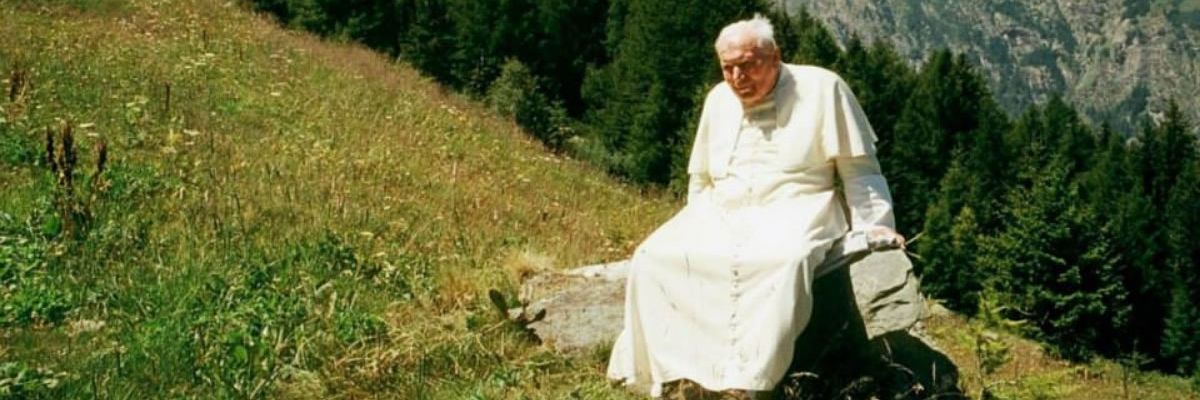 Pope John Paul sitting on a mountain side