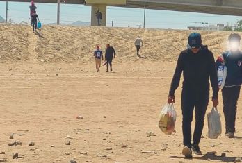 Migrants walking through the desert terrain in Ciudad Juárez